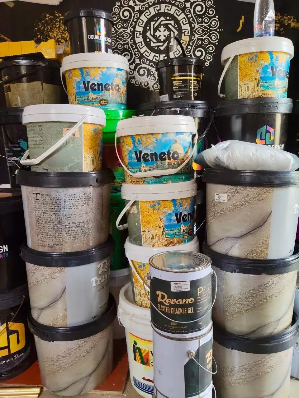 Paint buckets and finishing materials stacked in a warehouse