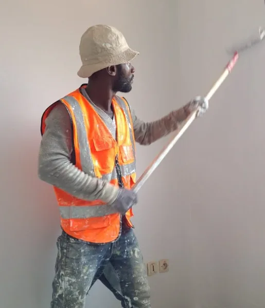 Painter rolling paint on an interior wall